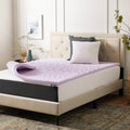 Lavender-infused memory foam mattress topper on a bed, purple quilted surface