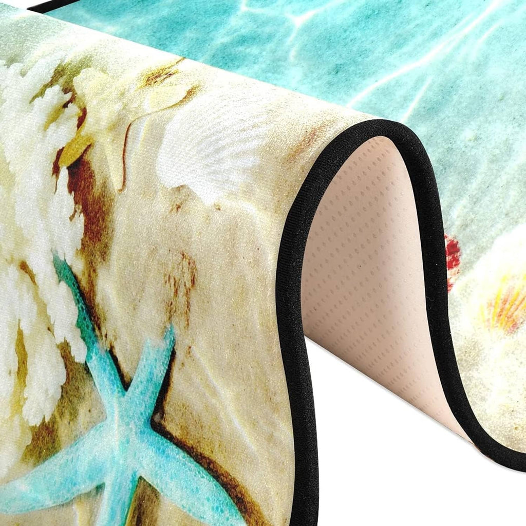 Close-up corner of teal ocean starfish rug with black trim and textured non-slip backing