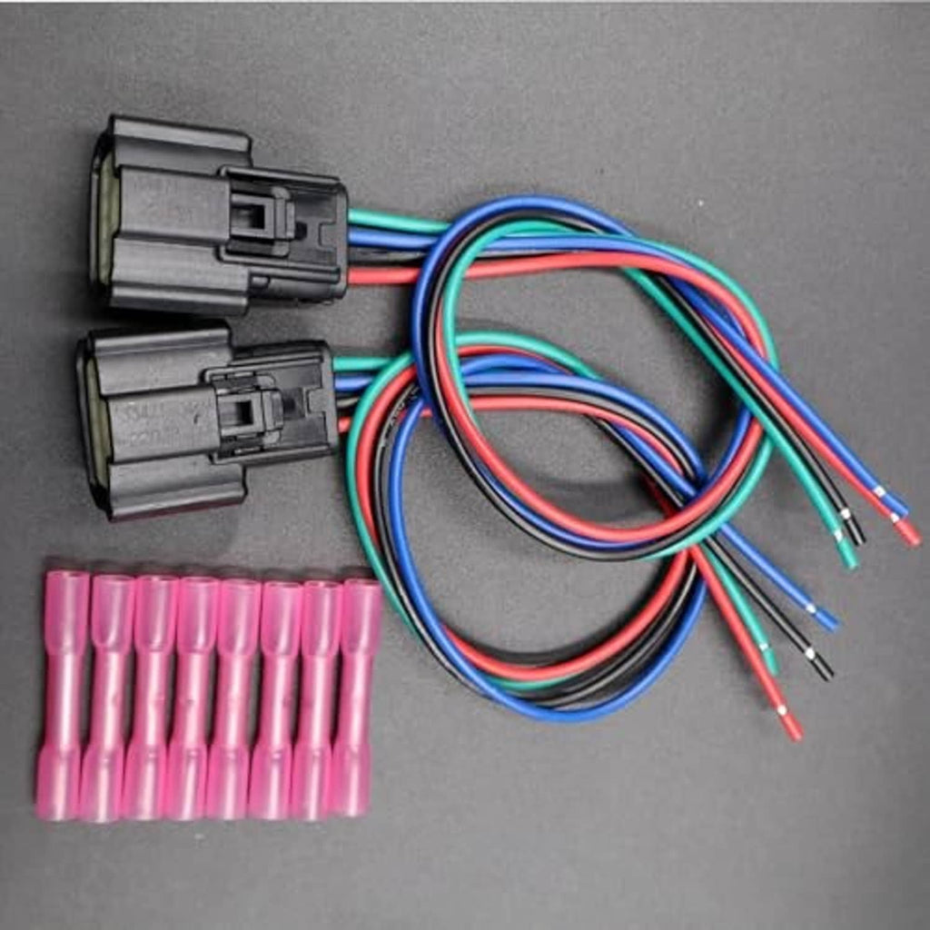 Two headlight wiring connectors with multi-pin plugs, colored wires, and pink terminals