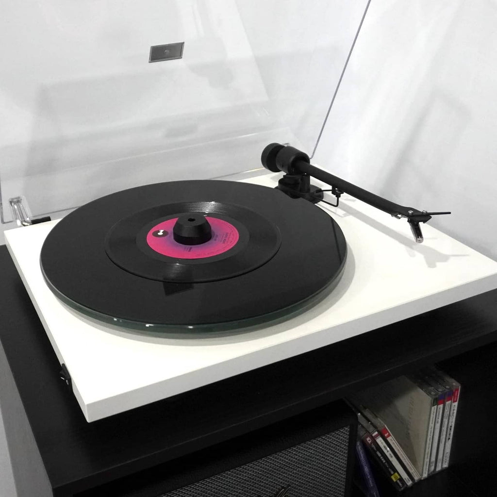 Black 45 RPM center adapter on 7-inch vinyl record platter