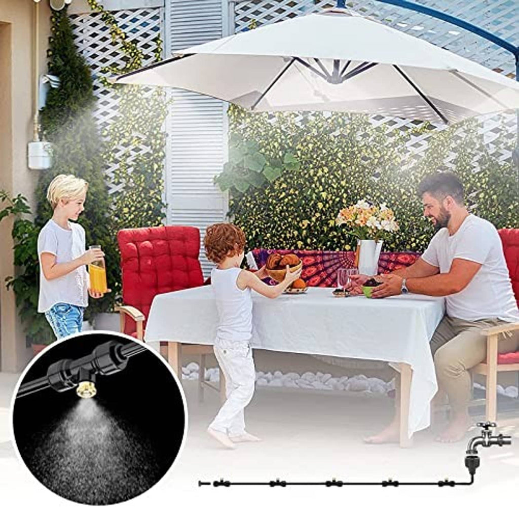 Black misting system with brass nozzle line spraying water for outdoor cooling