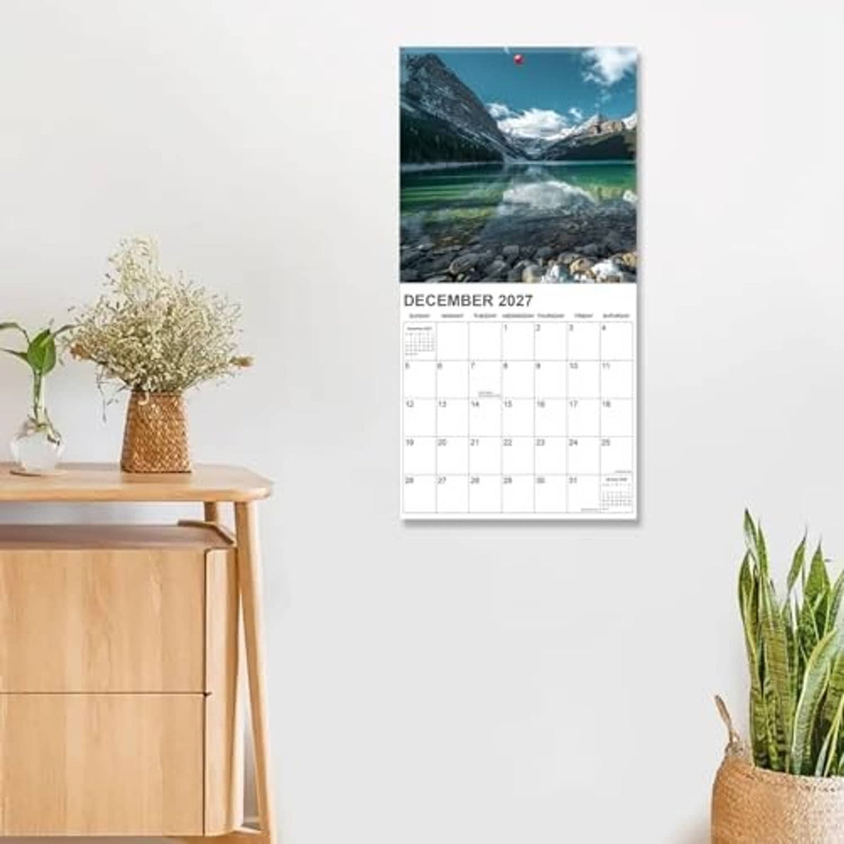 National Parks wall calendar hanging on wall, showing December 2027 with mountain stream photo.