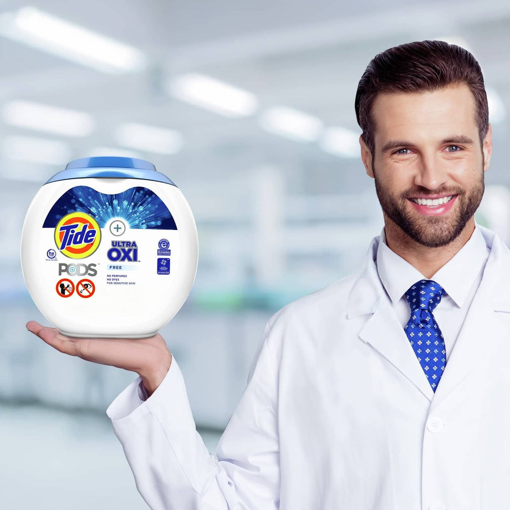 Tide Ultra Oxi Free laundry detergent pods container held by a smiling person