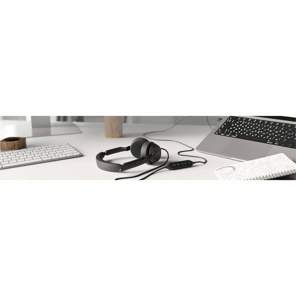 Black wired over-ear headset on desk with boom mic and inline control unit