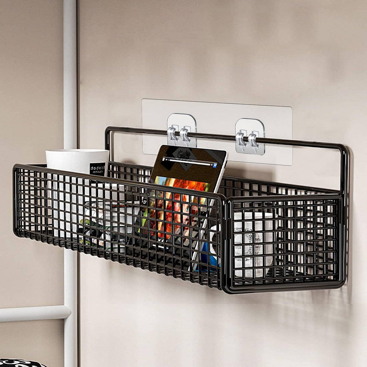 Black shower caddy with two adhesive hooks and metal grid basket on wall