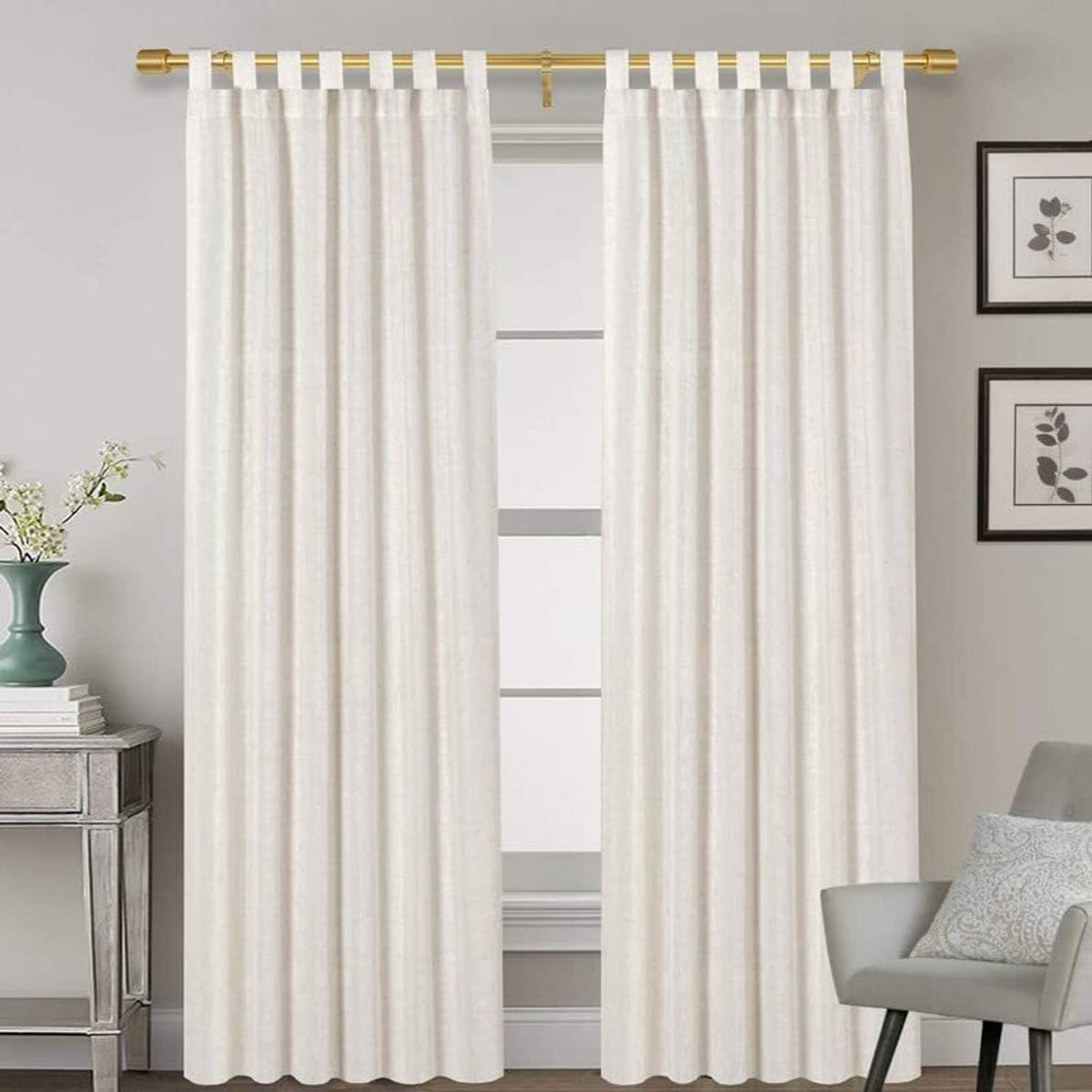 Gold curtain rod with cap finials above white grommet curtains
