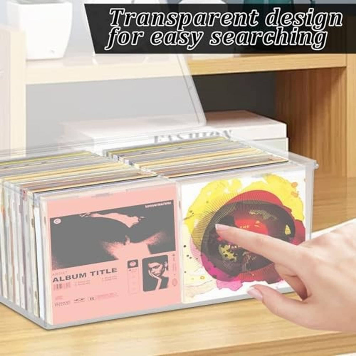 Clear CD storage box with open hinged lid, CDs inside and a hand reaching in