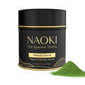 Black NAOKI matcha can with gold label and scoop of green powder