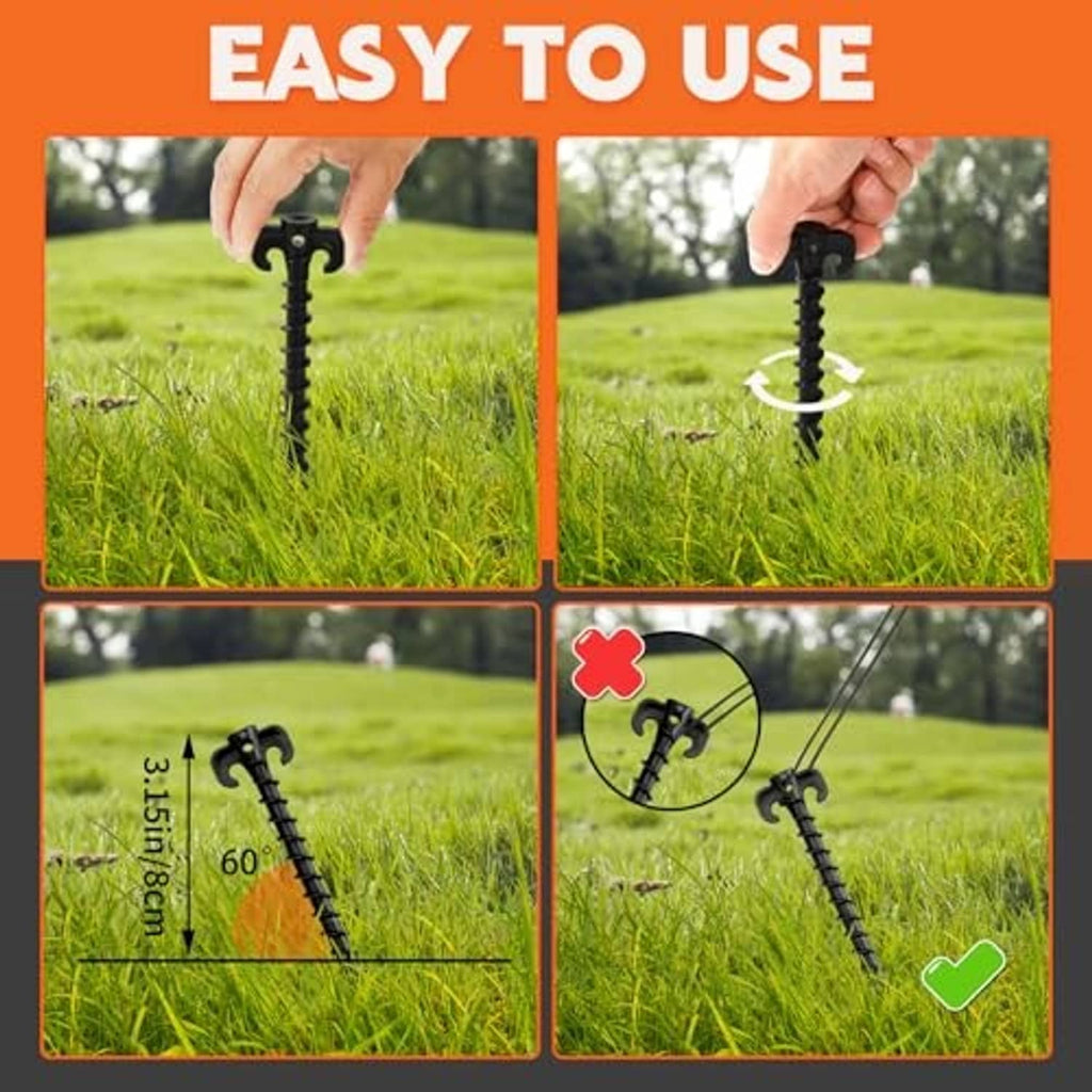 Black tent stakes with C-hook heads, pushed into grass for anchoring