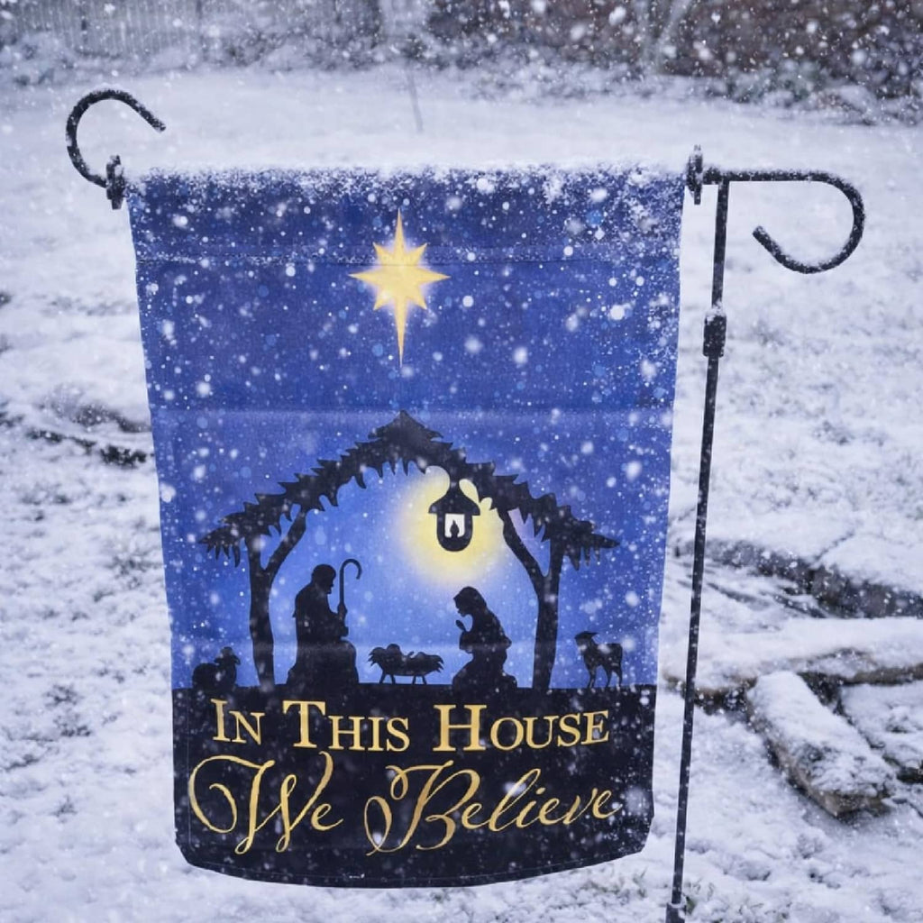 Winter scene garden flag with nativity silhouette and “In This House I Wye Believe”