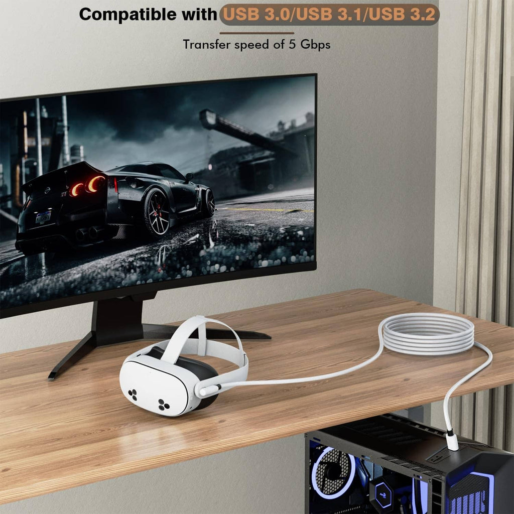 White VR link cable with USB-A plug connecting to a VR headset on a desk