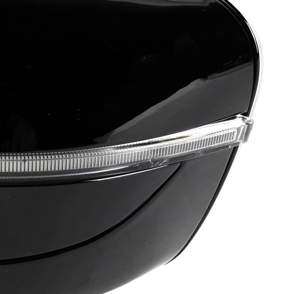 Close-up of black side mirror turn-signal strip and lens edge with glossy finish.
