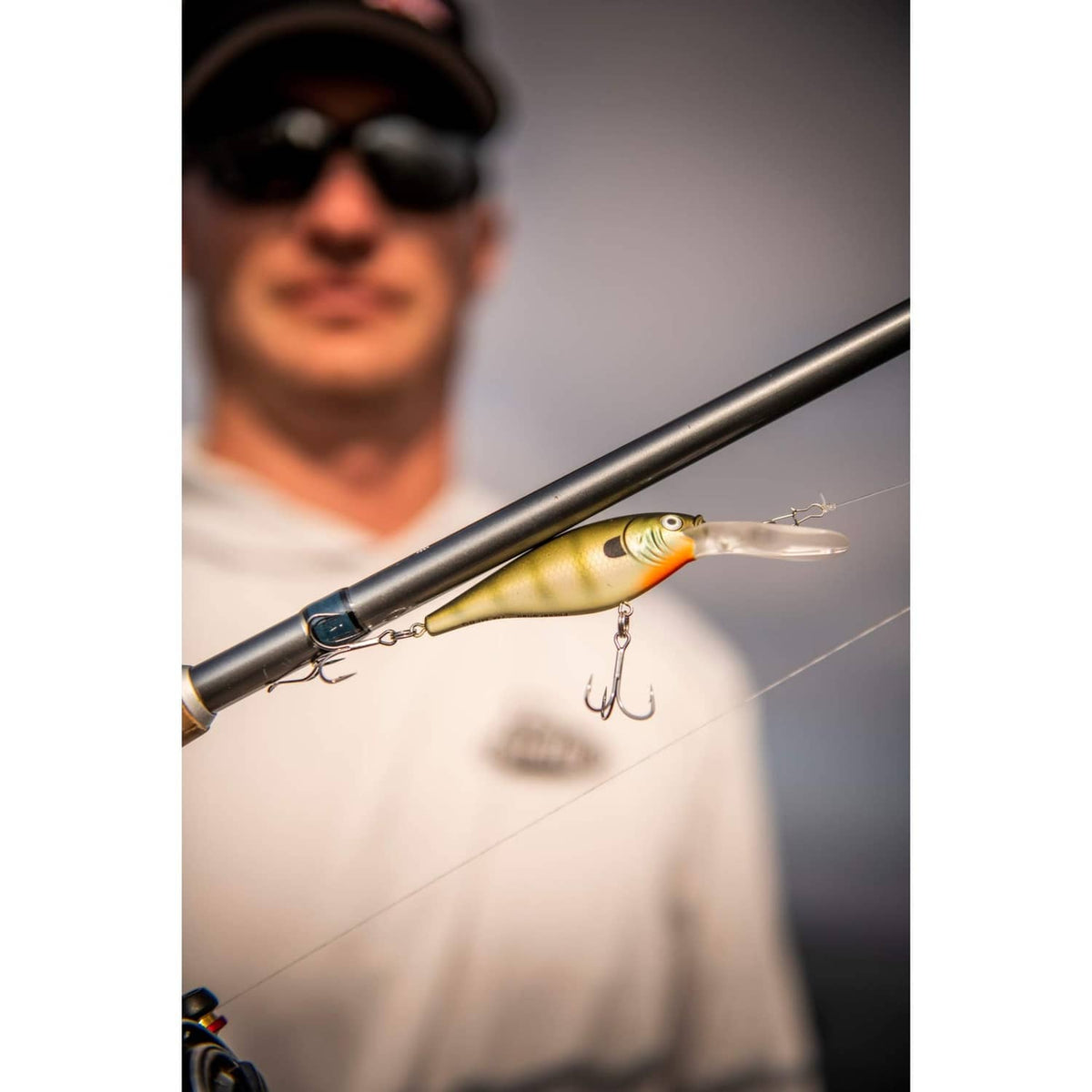 Gold and white crankbait fishing lure with red eye and treble hooks