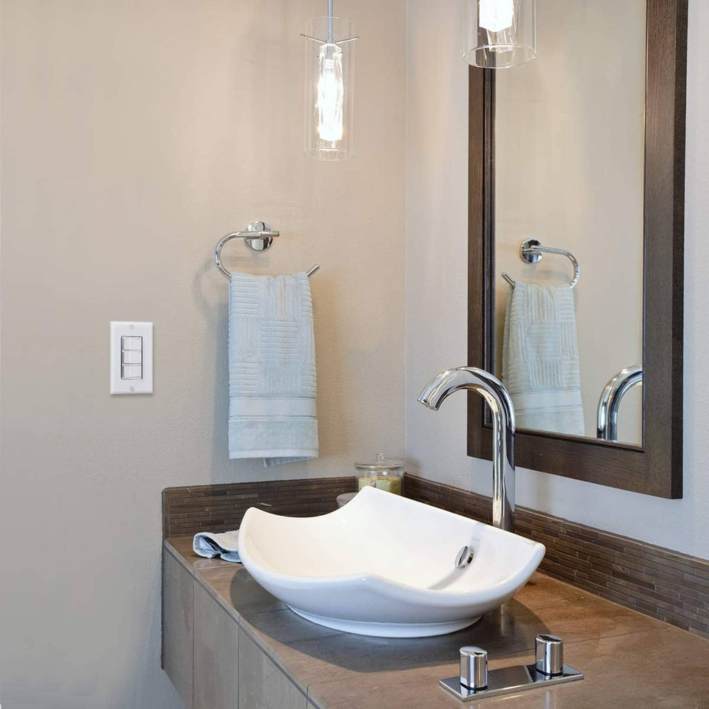 White triple rocker light switch on bathroom wall near sink