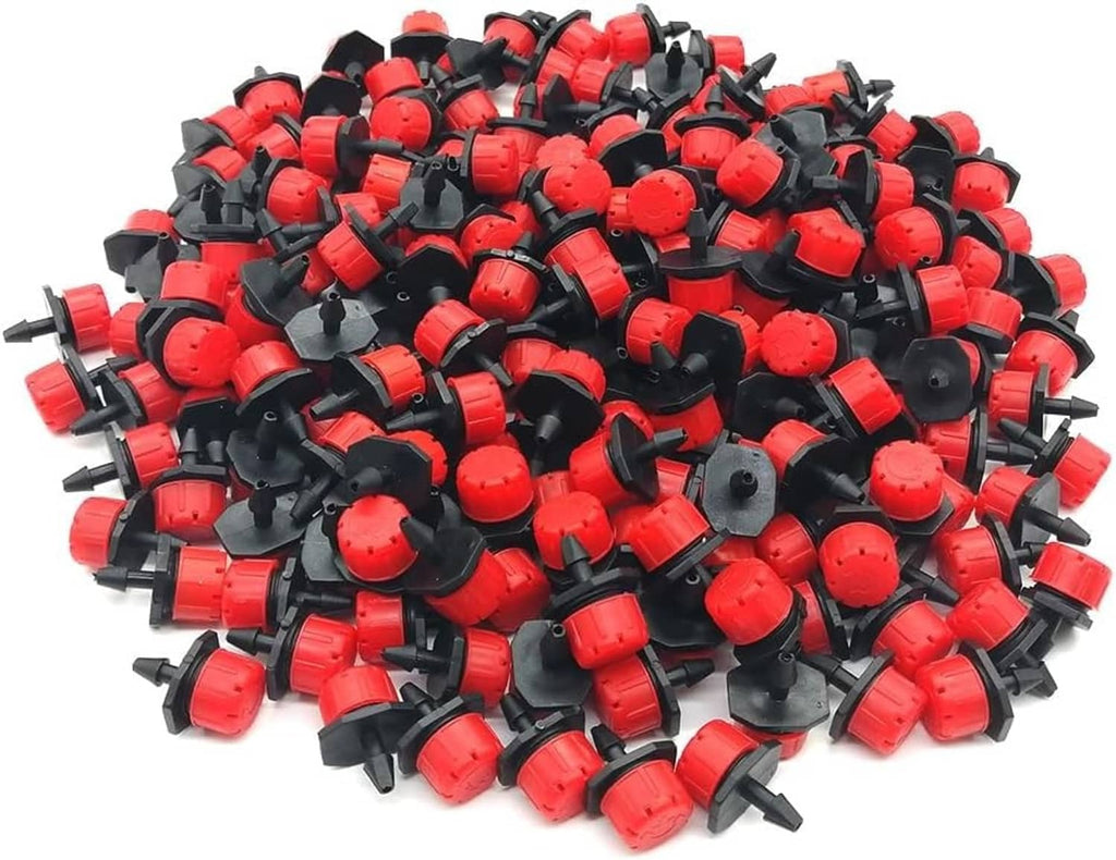 Small red and black drip irrigation emitters with adjustable flow tips