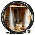 Black outdoor misting system hose with spray nozzles and water mist for cooling a coop