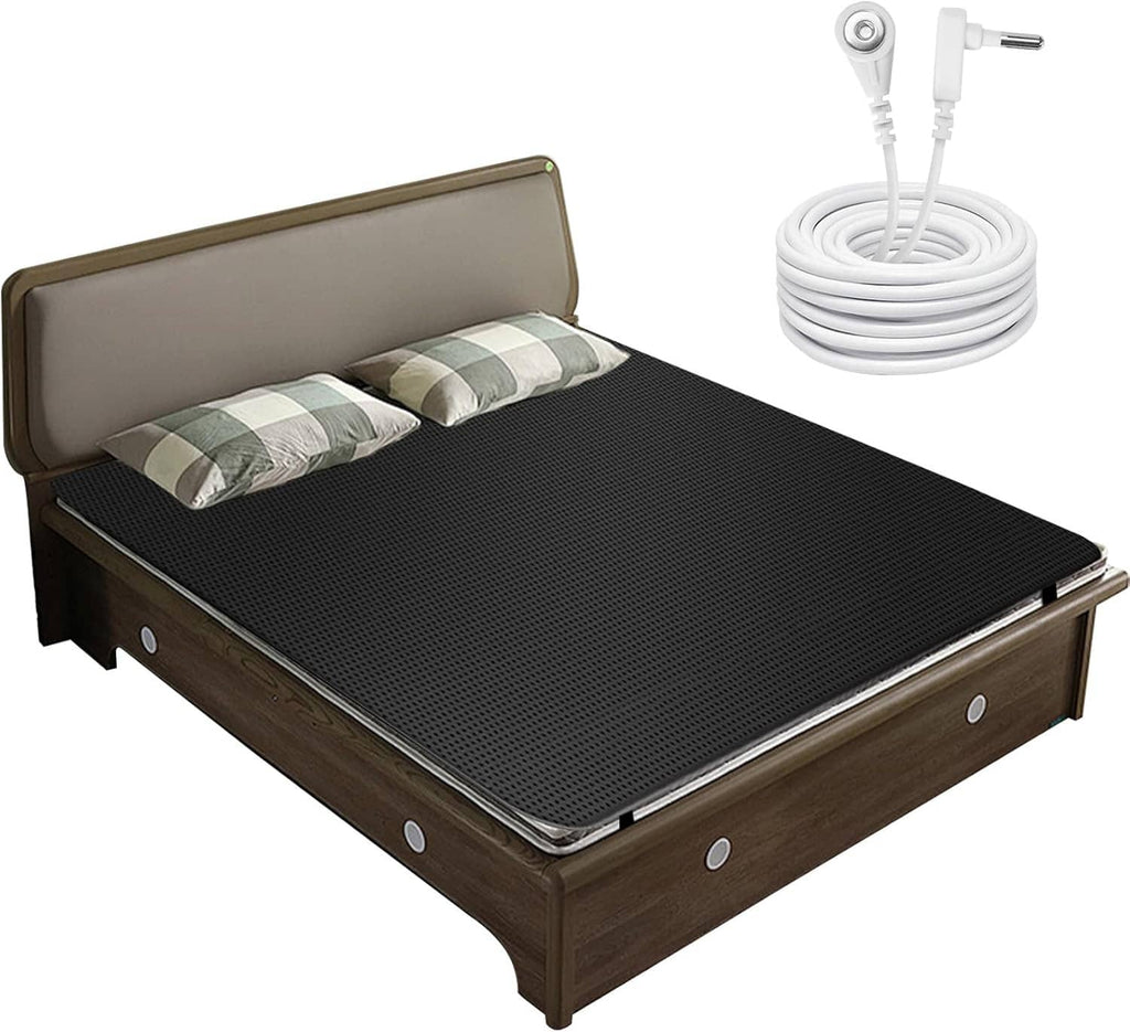 Bed grounding pad on dark textured surface with coiled grounding cable near headboard