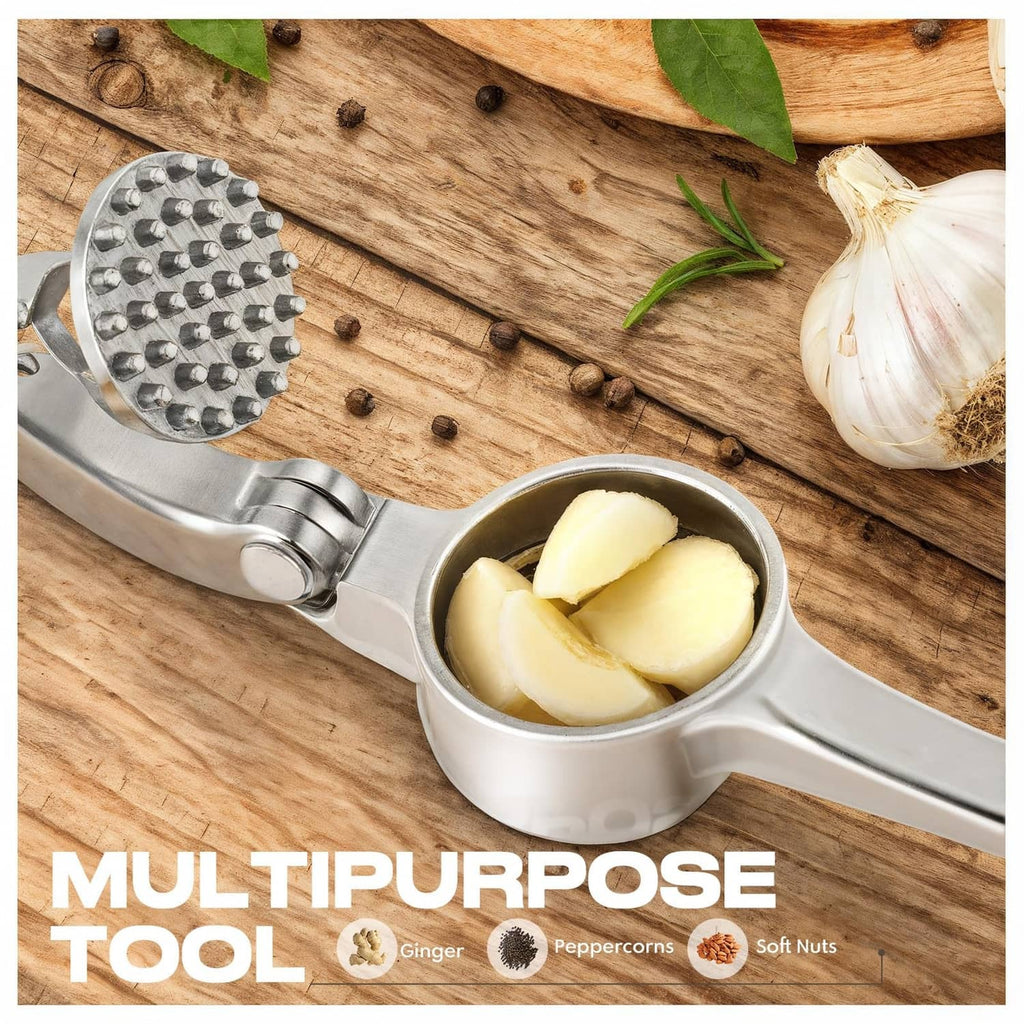 Garlic press with black grip and round studded plate, surrounded by garlic and spices