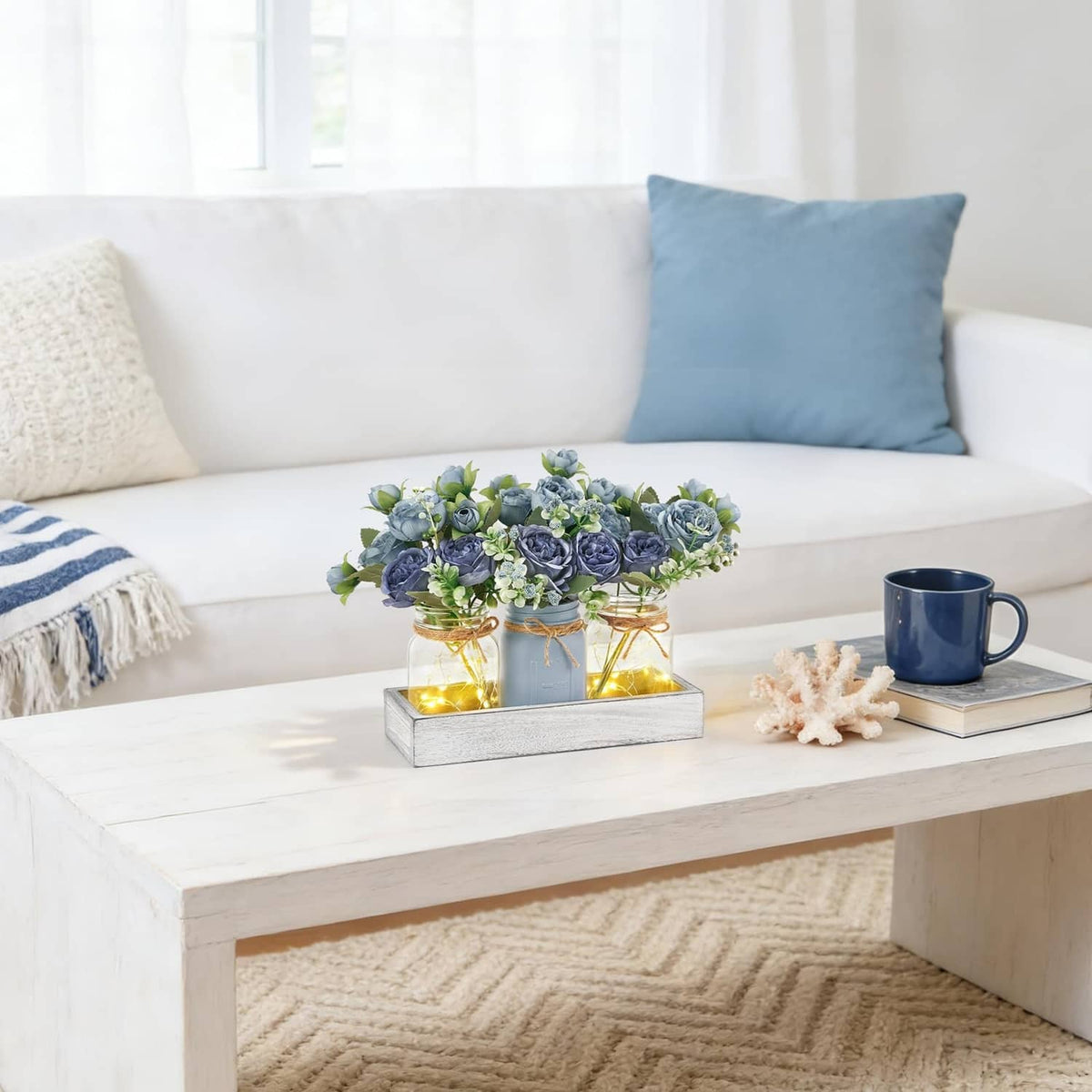 Blue flower mason jar light centerpiece in grey tray with glowing glass jars
