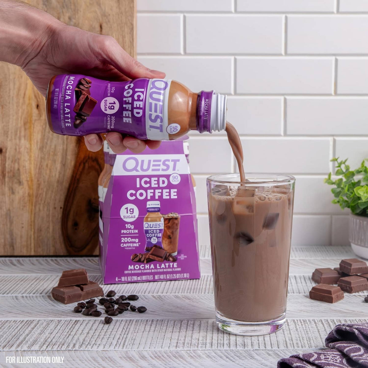 Hand pouring mocha latte iced coffee from bottle into a clear glass