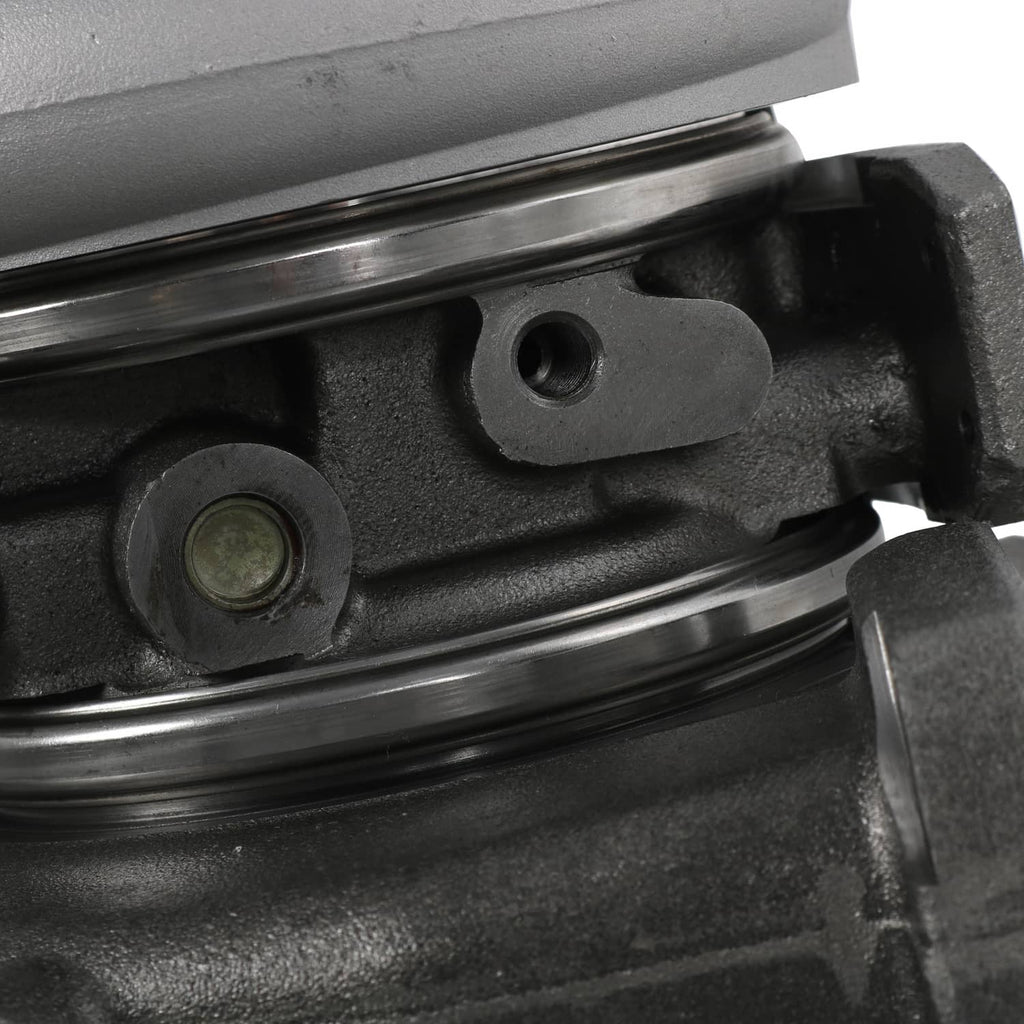 Turbocharger exhaust area with black linkage bar and oil-seal mounting detail