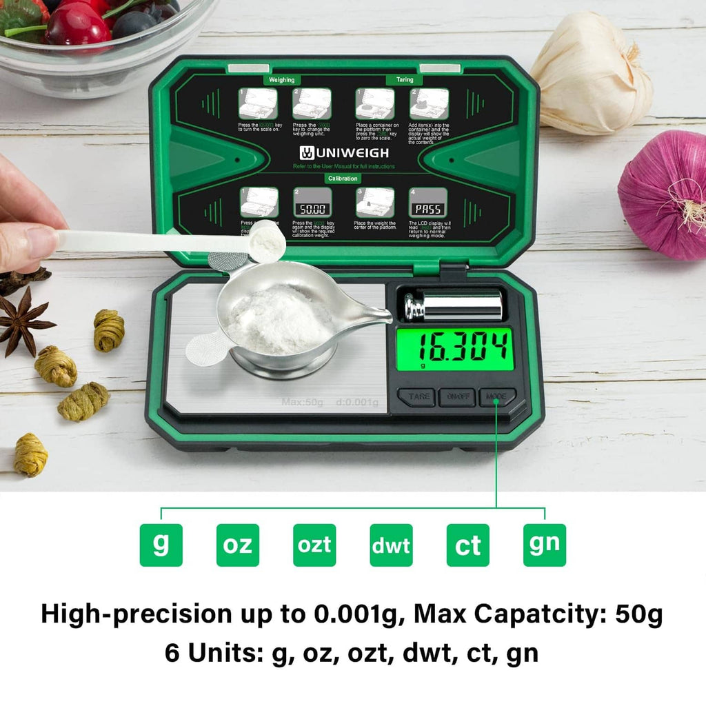 Milligram scale with silver weighing pan, green backlit LCD, and open protective case