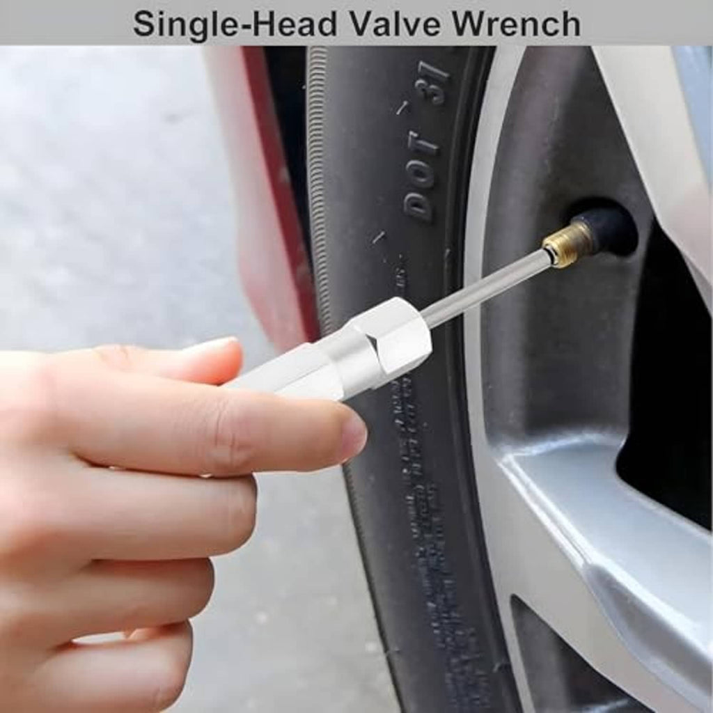 Hand using single-head valve wrench at a tire valve, white handle and metal rod