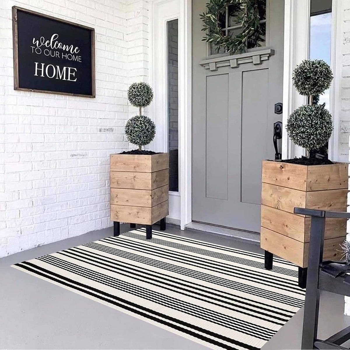 Rectangular black-and-white striped rug with wide horizontal bands and a flat woven surface.