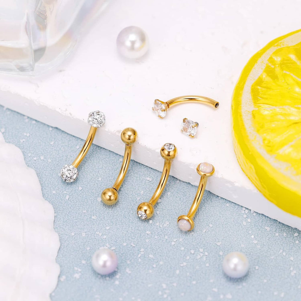 Gold belly button rings with CZ stones and round ball ends, arranged in a set