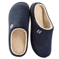 Navy blue men’s clog slippers with tan sherpa lining and cushioned footbed