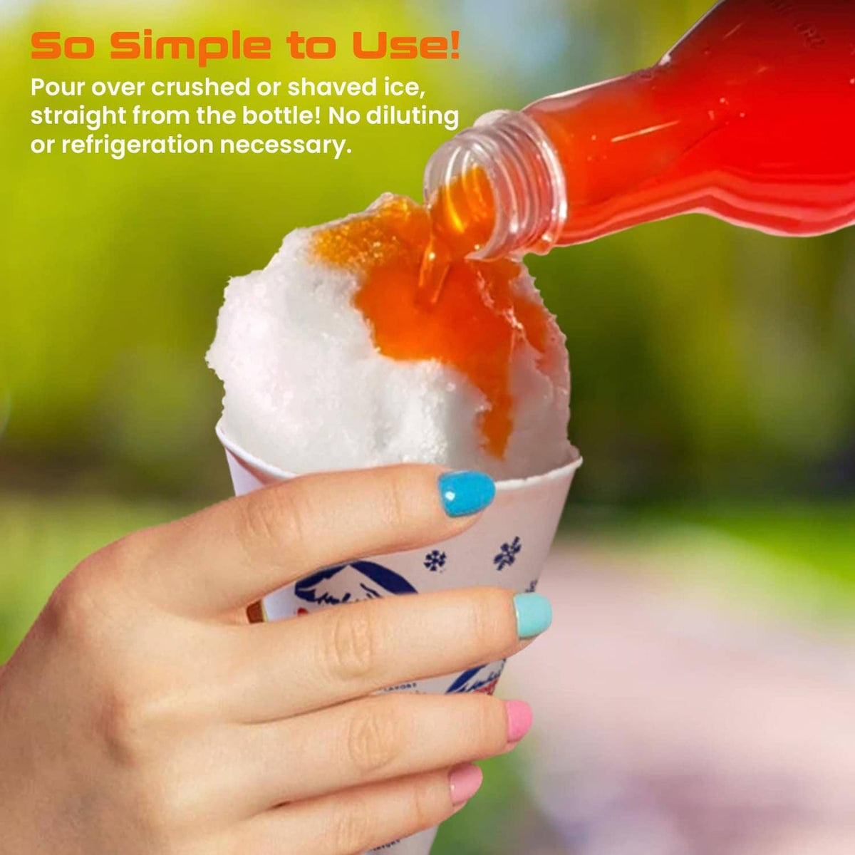 Orange Sno Cone syrup pouring onto crushed ice in a cup