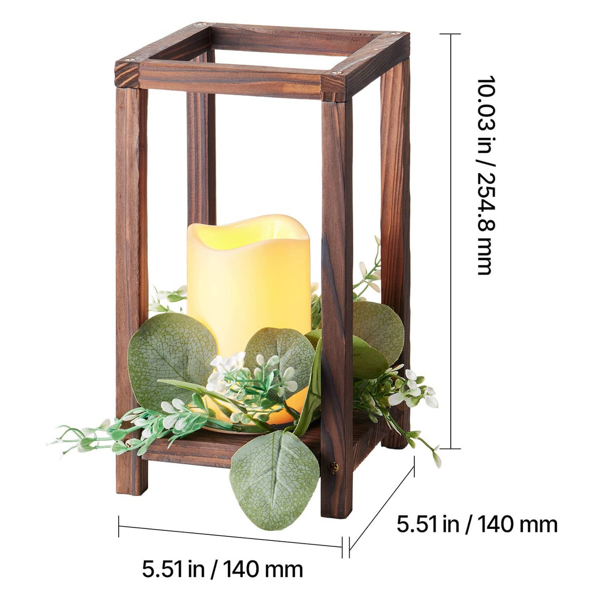 Close view of brown wooden lantern with glowing LED candle and eucalyptus greenery