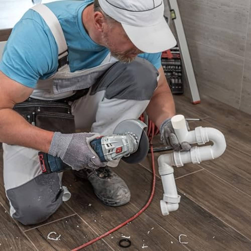 White PVC pipe end caps attached on plumbing pipe sections in a home repair