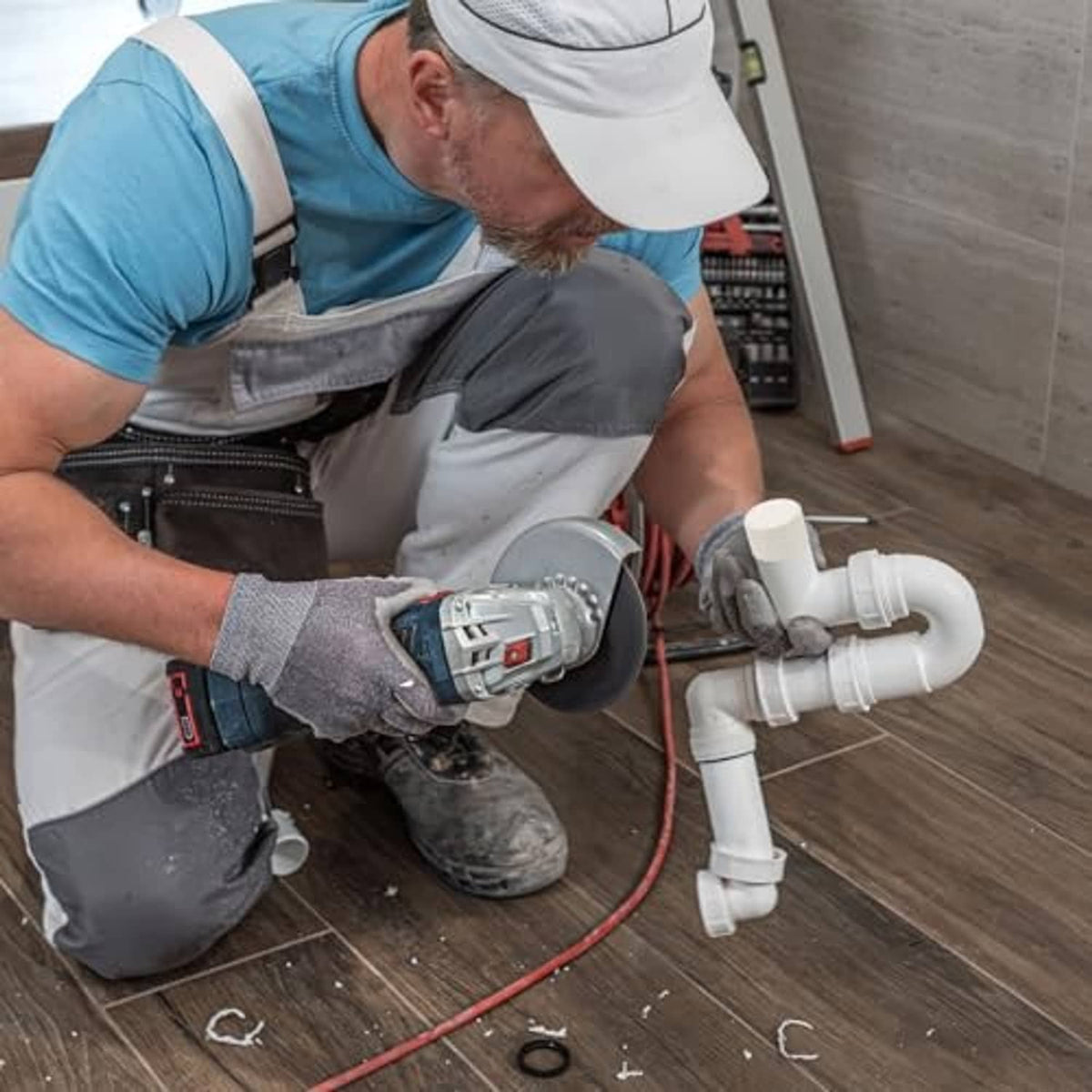 White PVC pipe end caps attached on plumbing pipe sections in a home repair