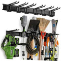 Black wall-mount tool organizer rail with dual hooks holding garden tools and brushes
