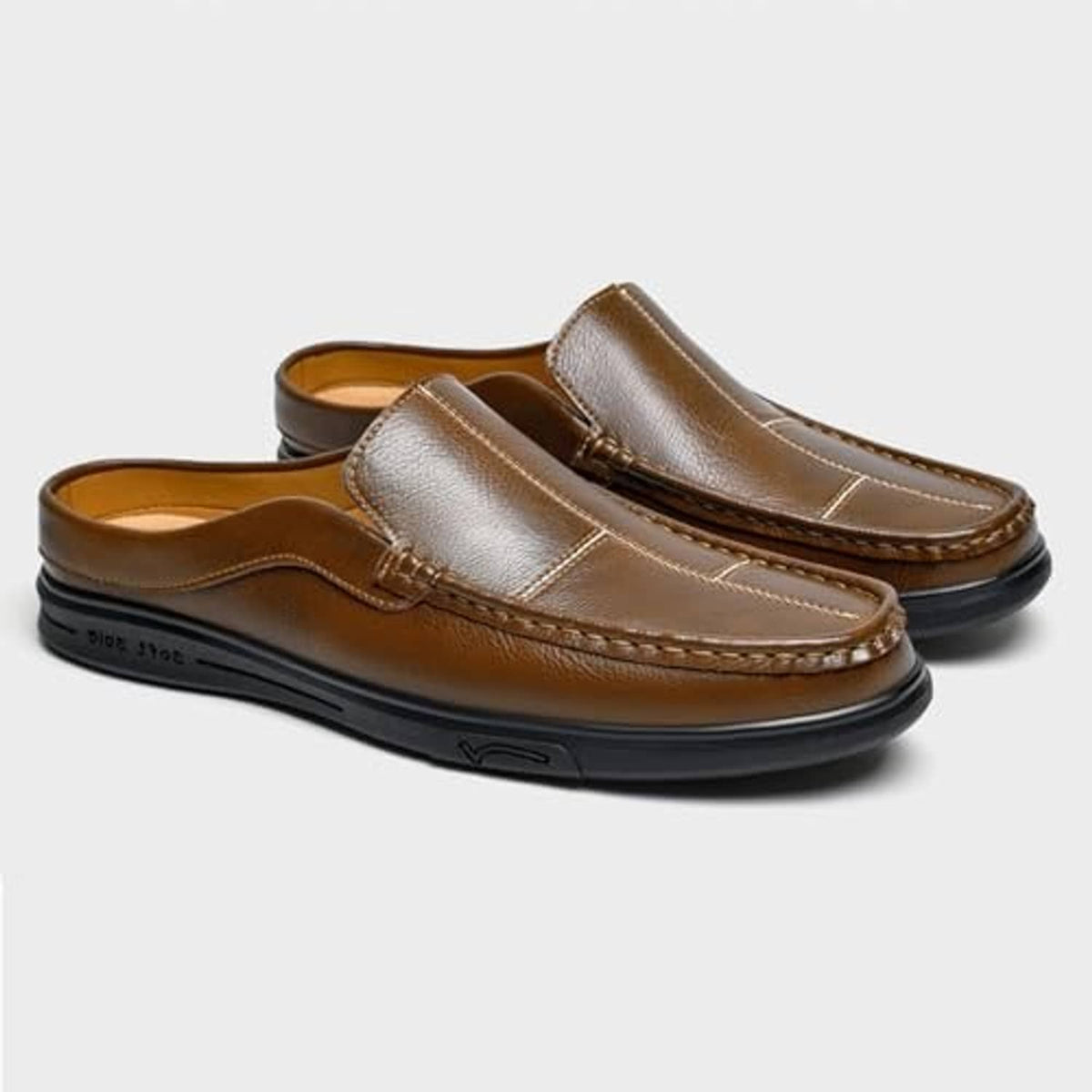 Brown leather slip-on mules with light tan strap panel and stitched collar