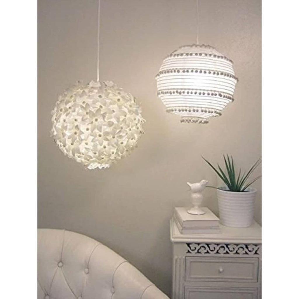 White round paper hanging lanterns, one textured and one striped, suspended from ceiling