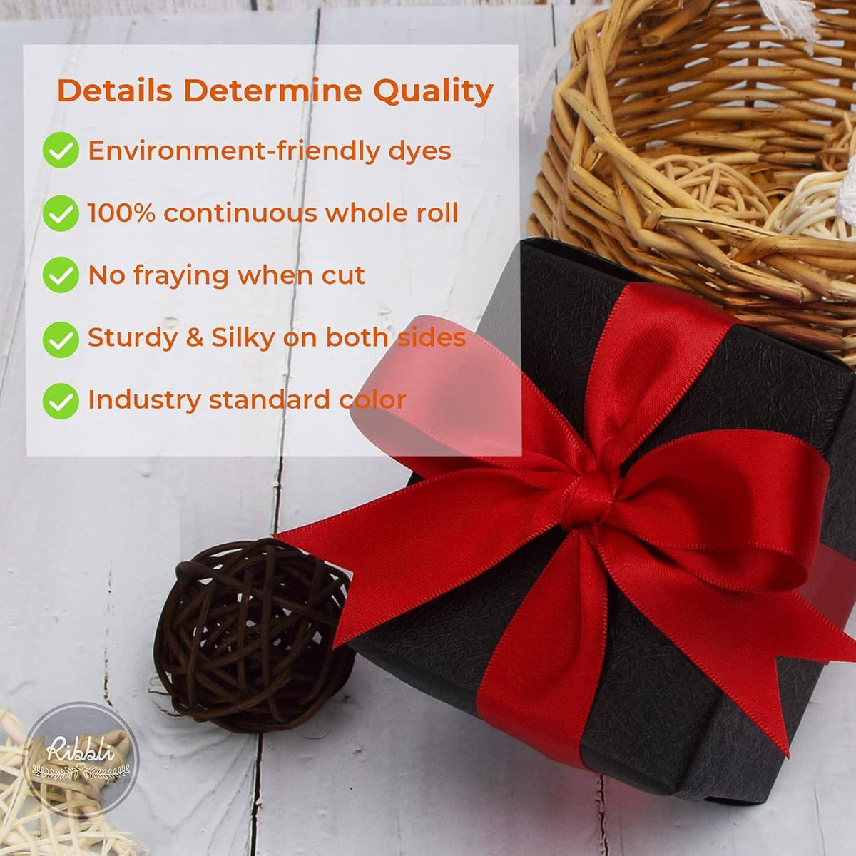 Red double-faced satin ribbon bow with layered folds on a black gift wrap