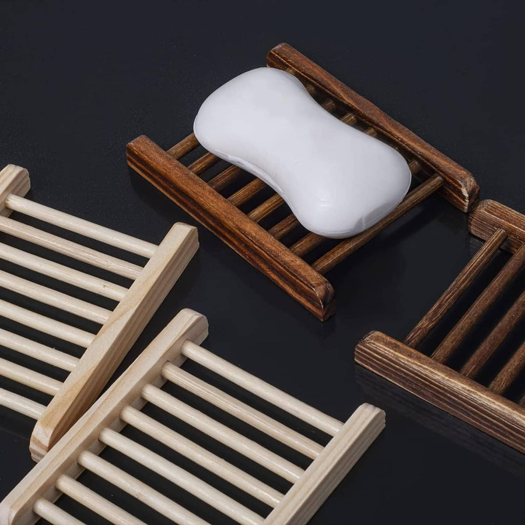 Dark bamboo soap holder with white soap bar on slatted drainage rack