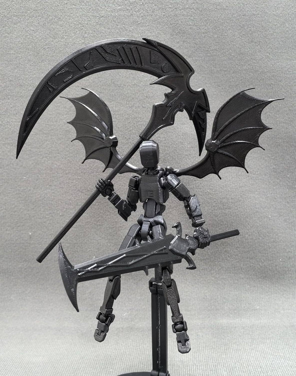 Titan 13 robot action figure with bat wings and mounted scythe, front view