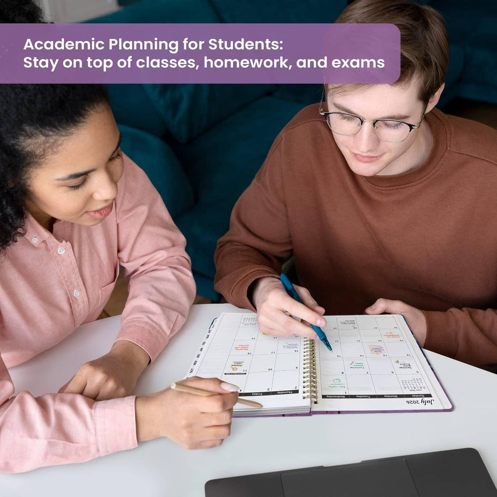 Students writing in an academic planner on a table during study time