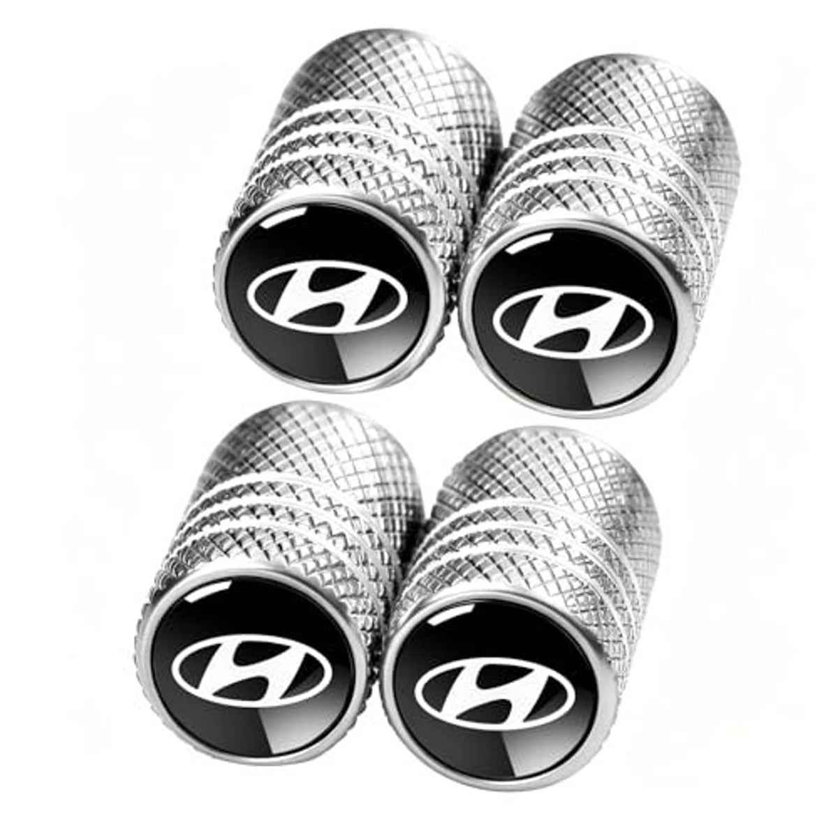 Four-pack silver plaid tire valve stem caps with black center logo emblem and ridged edge.