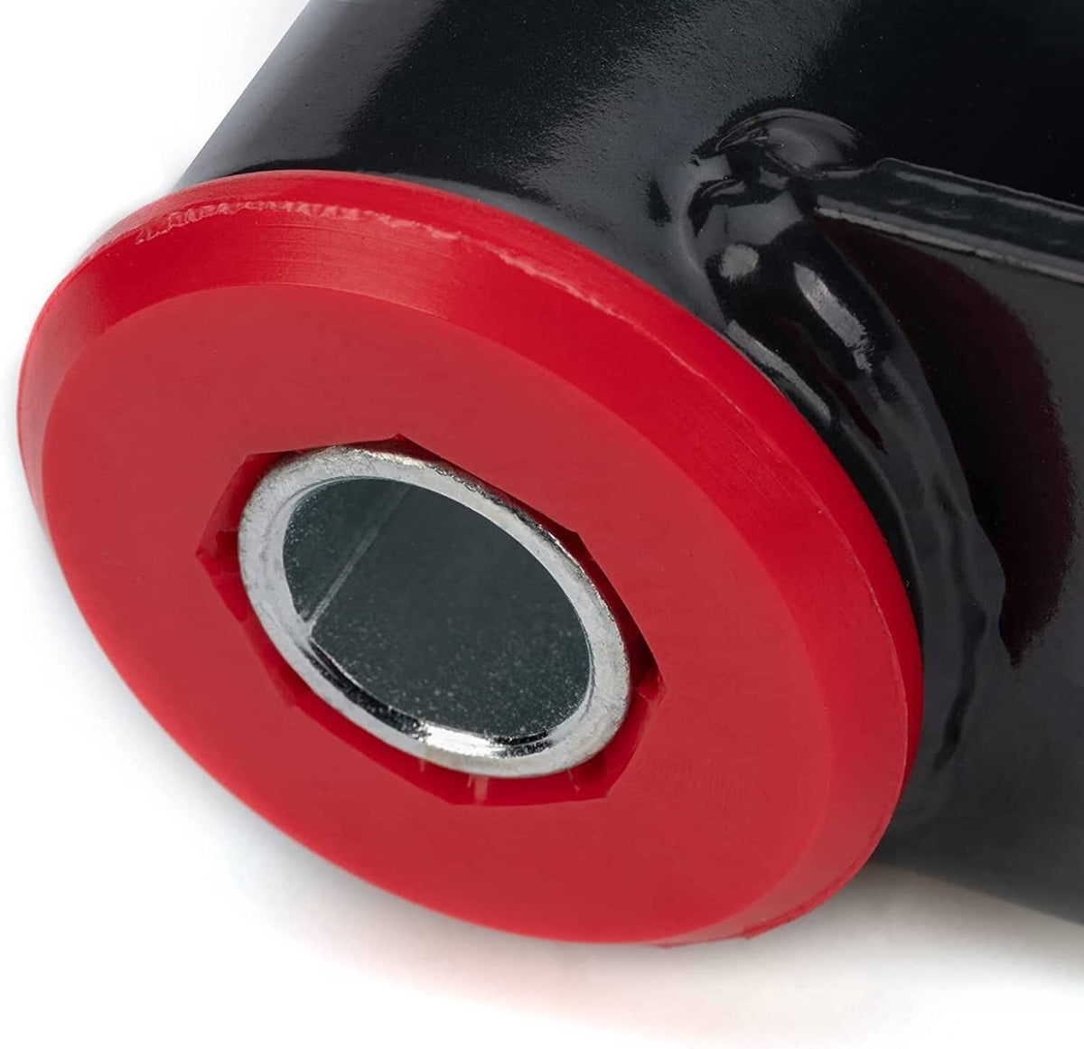 Red and black rear drop shackle bushing with metal mounting insert, close-up