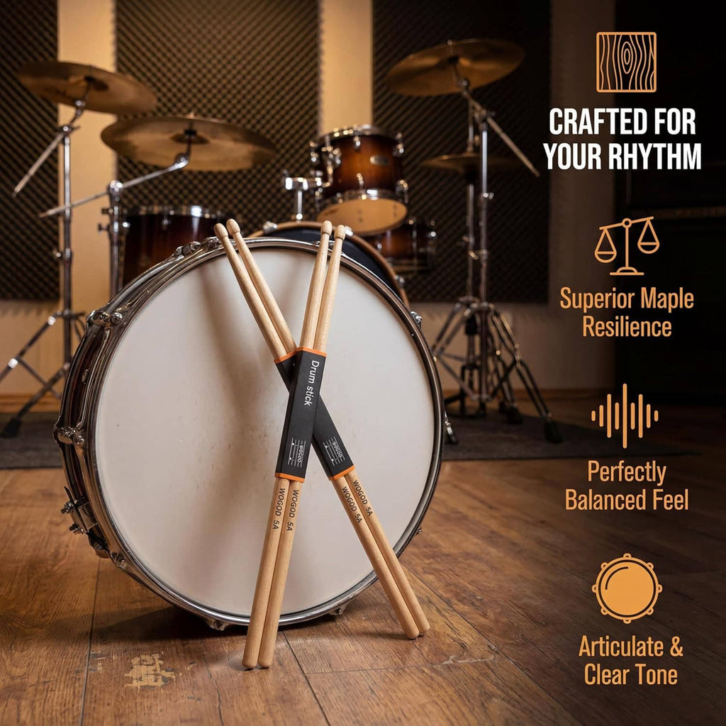 Two maple drumsticks standing in front of a bass drum, black label bands
