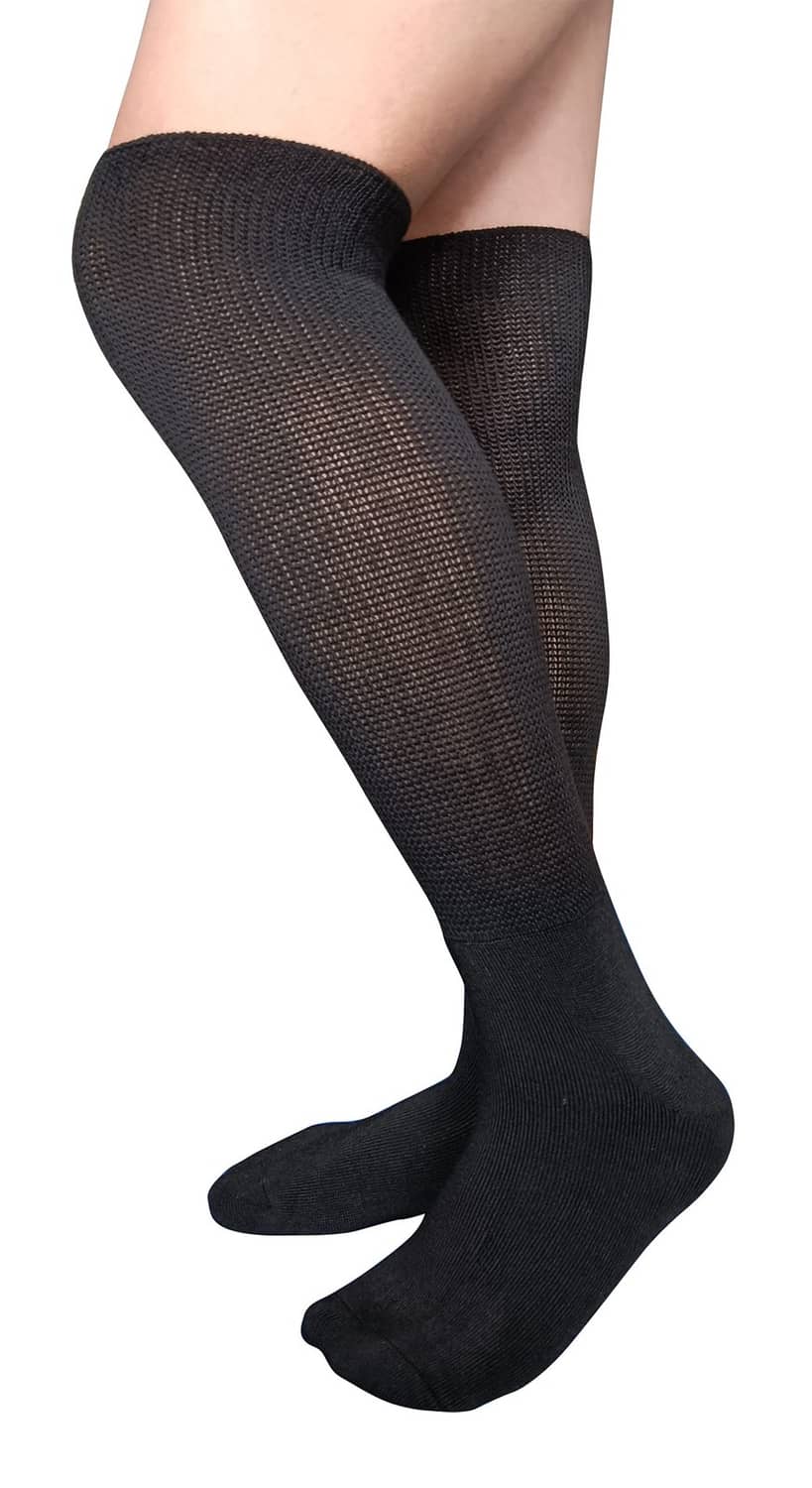 Black knee-high compression socks with sheer knit panels on the leg and foot