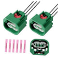 Green headlight wiring harness connector pair with 3-pin sockets and black wires