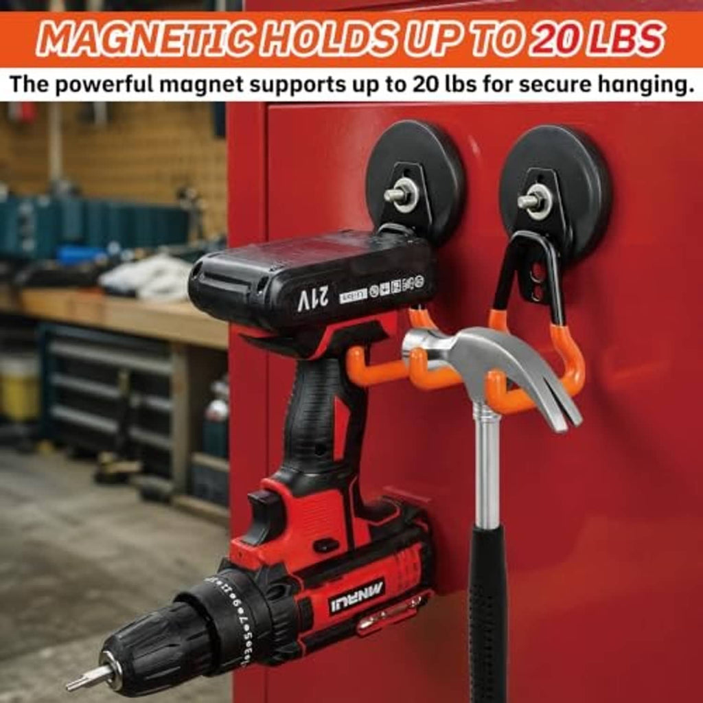 Black and orange magnetic hook holding a power drill on a wall surface