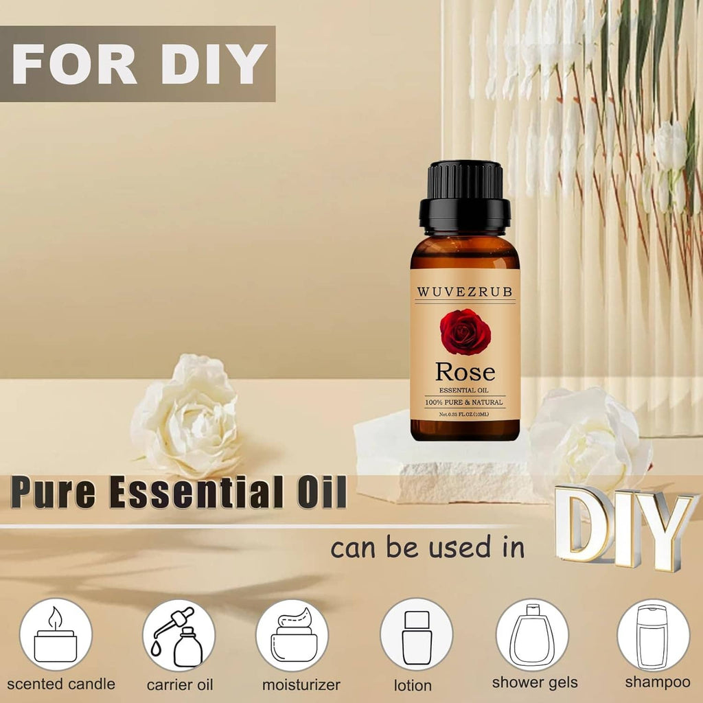 Rose essential oil bottle standing upright with beige label, next to white flowers.