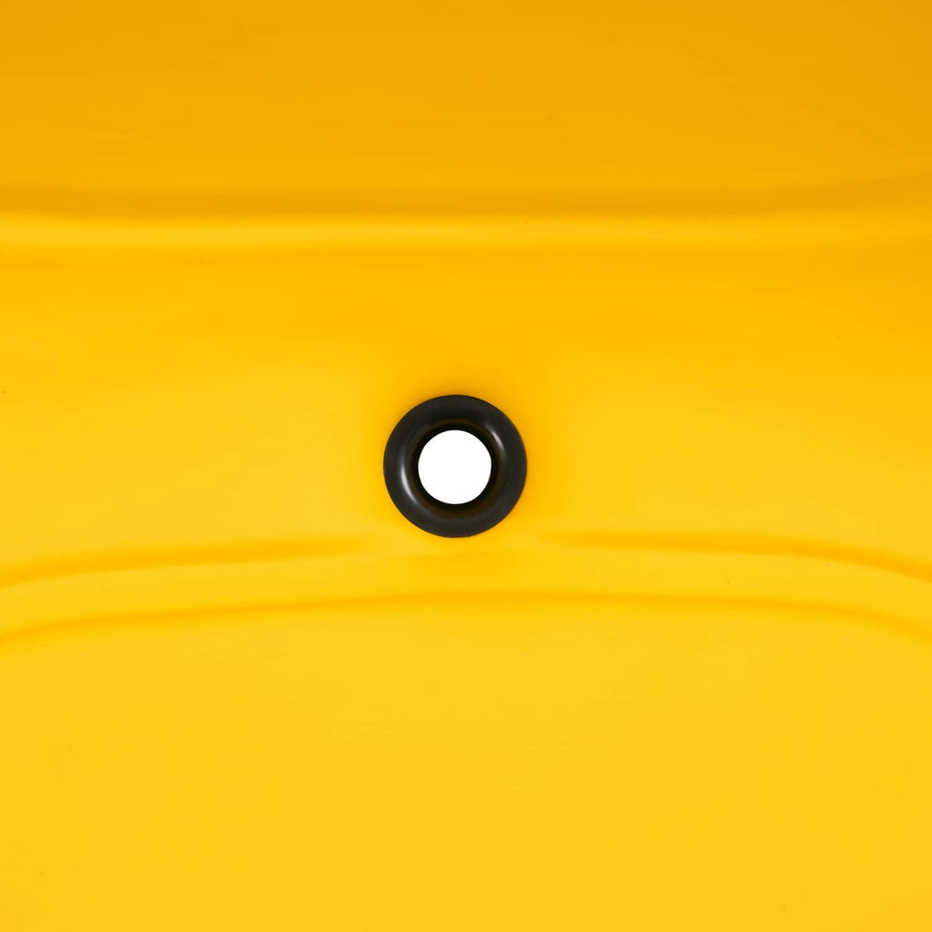 Drain hole on yellow plastic seat surface with black rubber grommet
