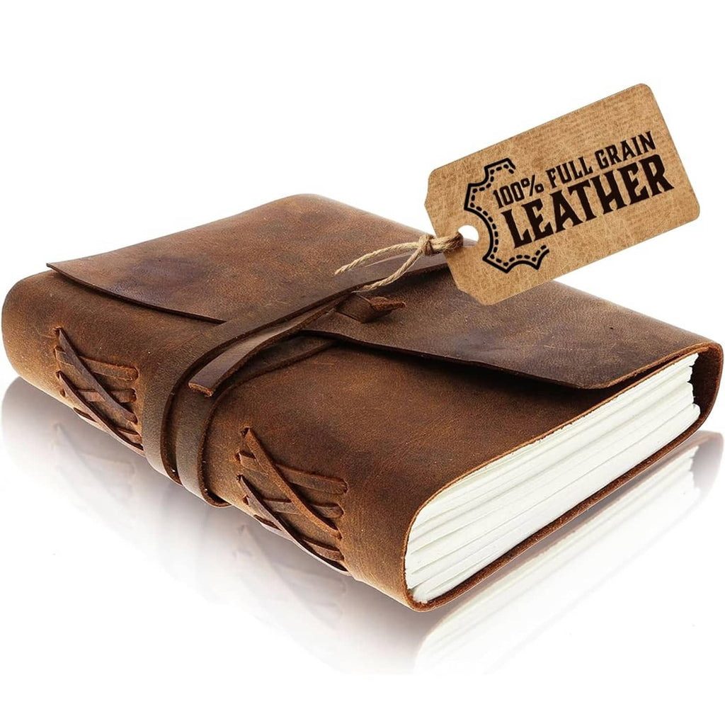 Vintage leather journal notebook with stitched cover and wrap-around closure strap.